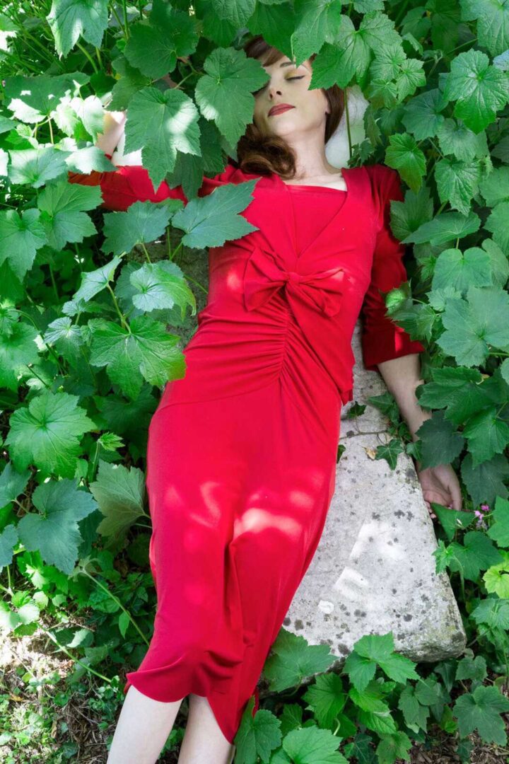 A red tango dress beneath leaves