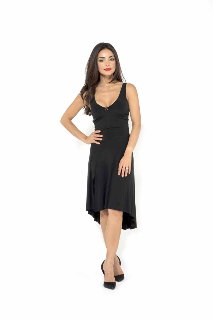 A woman is posing in a black dress.
