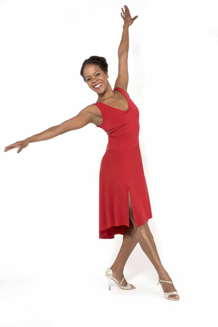 A woman in a red dress posing for the camera.