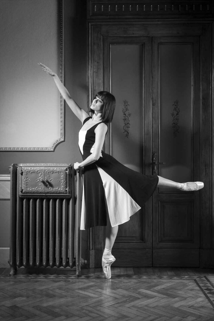 A black and white photo of a ballerina posing.