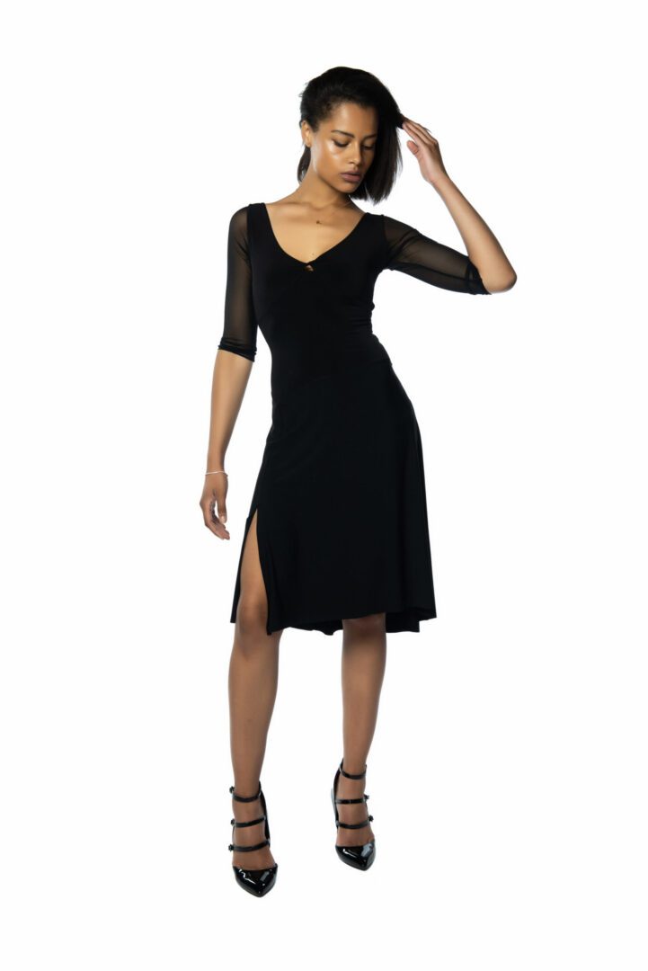 Model striking a pose with black errari tango dress
