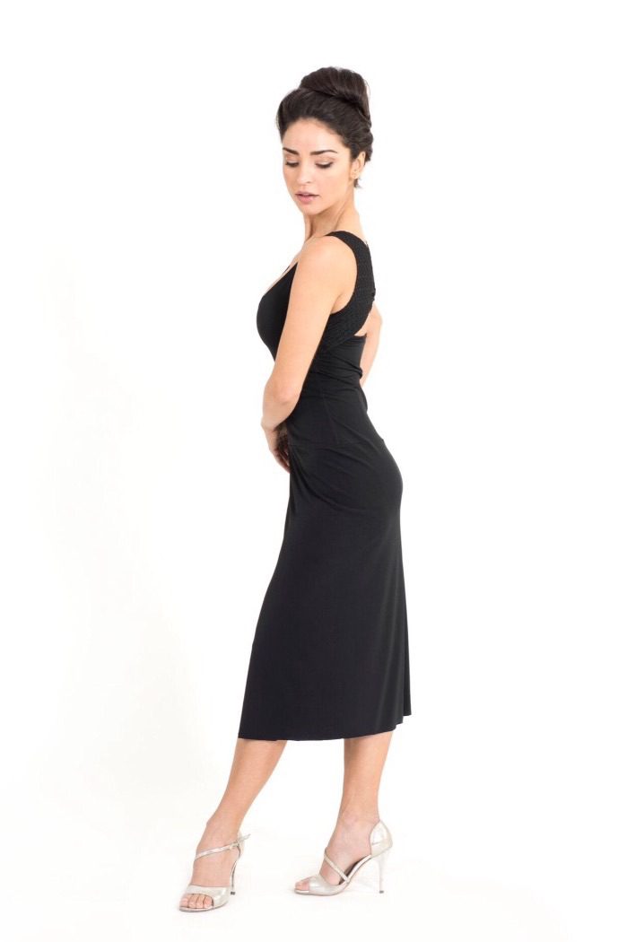 A black Tango dress with white heels side view