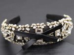 A black and white deeply padded headband with rhinestones