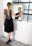 A glitter knot tango dress with a in front of a mirror