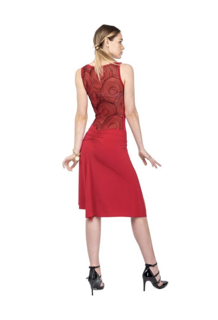 A woman strikes a back pose wearing a red dress