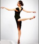A dancer wearing a black swan tango dress