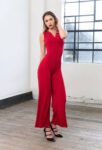 A red tango jumpsuit paired with black heels