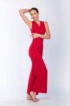 A woman in a beautiful red Tango apparel raising her arm