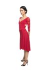A woman stands sideways wearing a satin dress