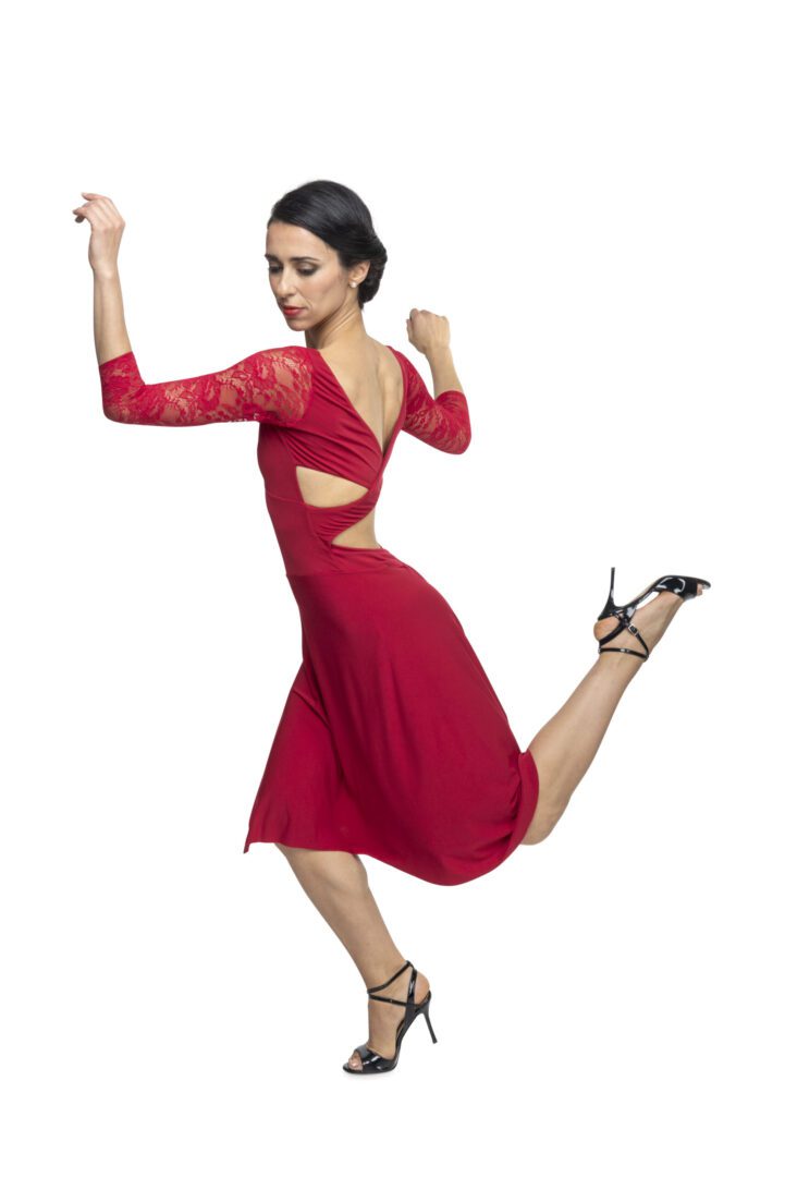 Image of model dancing with cross back red tango dress