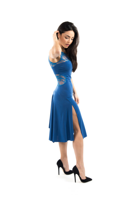 A woman in a blue dress and black heels side view